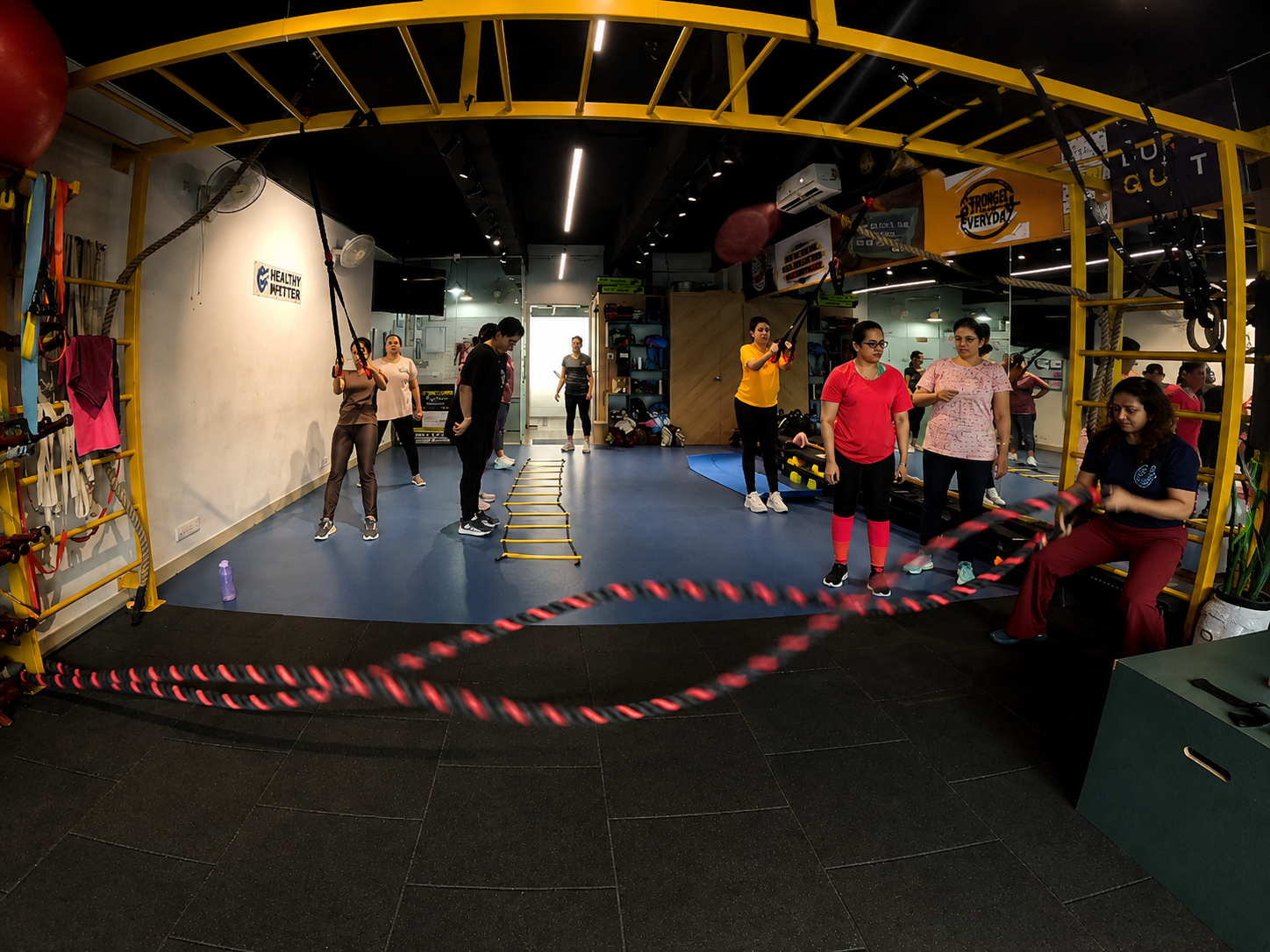 Group functional training with battle ropes and agility ladder